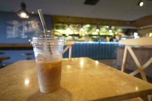 cold coffee in a plastic container with smile shape design on it photo