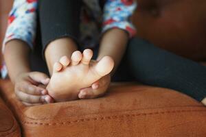 6 year old child suffering pain on feet photo