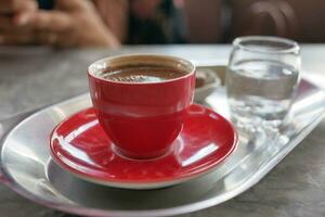 a cup of turkish coffee on table photo