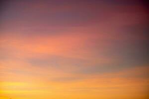 Beautiful of luxury soft gradient orange gold clouds and sunlight on the blue sky perfect for the background, take in everning,Twilight photo