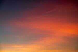 Beautiful of luxury soft gradient orange gold clouds and sunlight on the blue sky perfect for the background, take in everning,Twilight photo