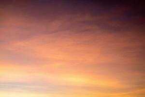 Beautiful of luxury soft gradient orange gold clouds and sunlight on the blue sky perfect for the background, take in everning,Twilight photo