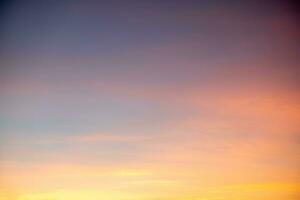 Beautiful of luxury soft gradient orange gold clouds and sunlight on the blue sky perfect for the background, take in everning,Twilight photo