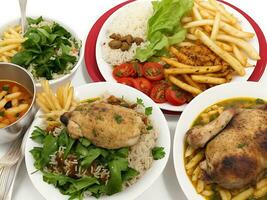 Free photo dinner set with dolma soups, salads and chicken with rice and french fries Generative Ai