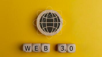 Web 3.0 concept image with Wooden cubes with the word WEB 3.0 on a yellow background. Technology and WEB 3.0 concept. photo