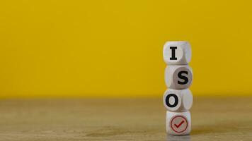 ISO standards verification, quality control certification approval. Cubes with the word ISO and a tick on a yellow background. photo