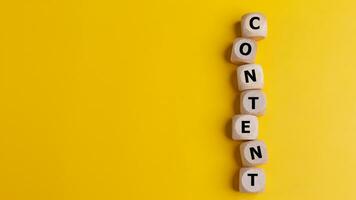 Cubes with the word CONTENT on a yellow background.Content creation or management in business information technologies. Business concept photo