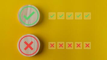 Right and wrong or voting yes or no concept. Wooden blocks with check marks on a yellow background. The idea of choice. photo
