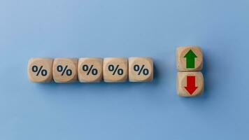 Cube block with percentage symbol icon. Interest rate financial and mortgage rates concept. Wood cube change arrow down to up. Interest rate, stocks, ranking. Business and finance concept. photo