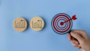 Goal and graph icons on wooden blocks, Business growth success process, Business achievement goal and target, Planning and development for the corporation. photo