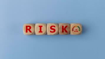 Risk level indicator rating print screen wooden cube block since low to high on blue background for Risk management and assessment concept. photo