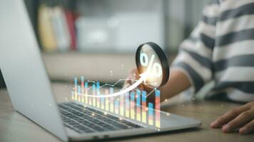 Interest rate and dividend concept. Women with magnifying glasses and percentage symbols and an up arrow, interest rates continue to increase, and return on stocks and mutual funds. photo