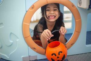 Happy Asian child girl in a witch costume to Halloween. trick or treat. Kids trick or treating. photo