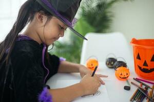 Happy Asian child girl in a witch costume to Halloween. trick or treat. Kids trick or treating. photo