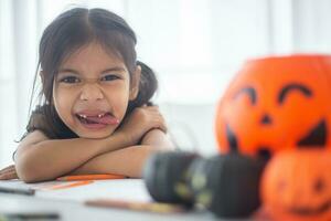 Happy Asian child girl in a witch costume to Halloween. trick or treat. Kids trick or treating. photo