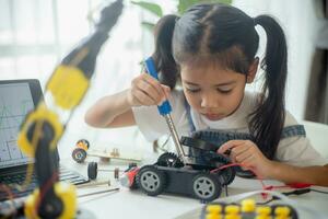 STEM education concept. Asian young girl learning robot design. photo