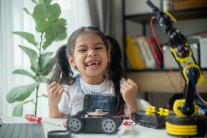 STEM education concept. Asian young girl learning robot design. photo