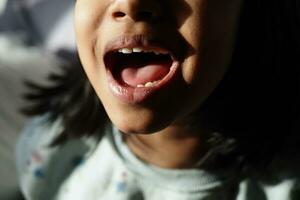 close up of child screaming at home photo