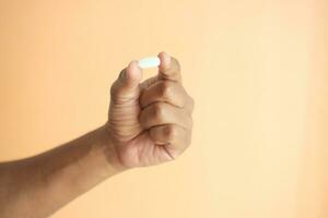 Close up of man hand holding pills with copy space photo