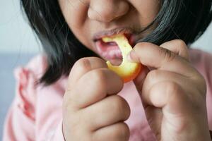 child mouth eating gummy candies closeup photo