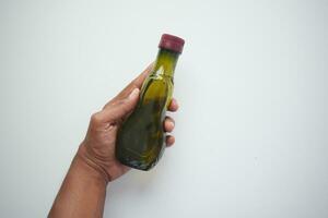 hand holding a bottle of olive oil photo