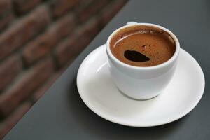 a cup of turkish coffee on table photo