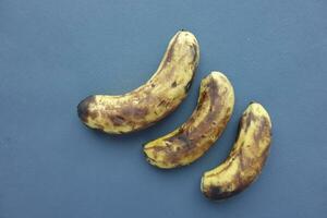 comparing rotten banana with a ripe banana on a white background photo