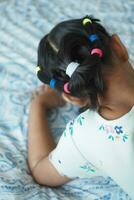 Beautiful ribbon is tied on a child hair photo