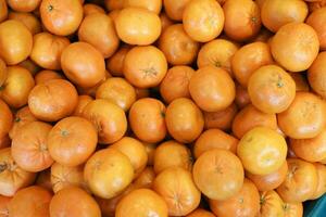 close up of slice of orange fruits in a bowl photo