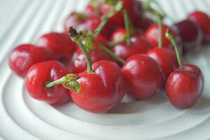 ripe fresh cherry on a white tray photo