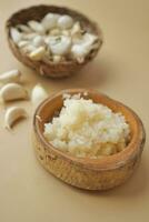 close up of minced garlic on a wooden bowl photo