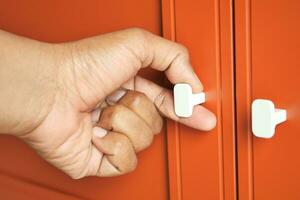 hand opening bedroom cabinet door photo