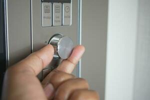 Close up of men hand setting temperature control on oven. photo