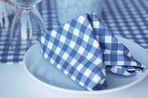 Empty plate, silverware and towel on table photo