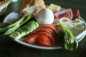 turkish breakfast of cheese, cucumber, egg, olive and tomato photo