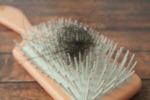 a brush with lost hair on table photo