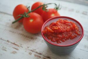 Tomato paste with ripe tomatoes. photo