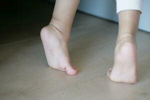 low angle view of A child walking on tiptoes photo