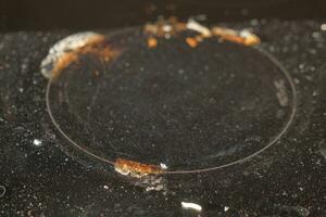 A black dirty electric stove. closeup . photo