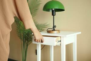 women hand open drawer wooden in cabinet photo