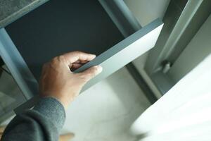 top view of men hand open a a drawer photo