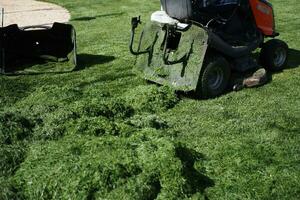 Lawn mower on grass in garden, photo