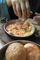 Turkish Menemen omelet in a frying pan. . photo