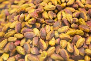 Pistachio kernel nuts background closeup photo