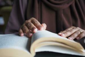 Close up of women hand turning a pager of a diary photo