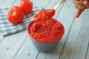 Tomato paste with ripe tomatoes. photo