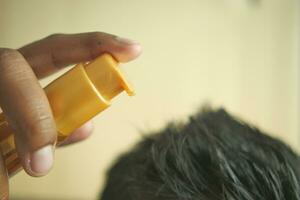 men applying oil on hair photo