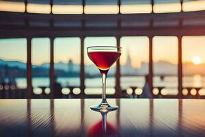 un vaso de rojo vino en un mesa en frente de un ciudad vista. generado por ai foto