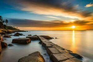 a sunset over the ocean with rocks and a wooden walkway. AI-Generated photo