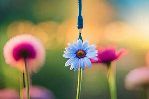 a blue and white flower is hanging from a string. AI-Generated photo